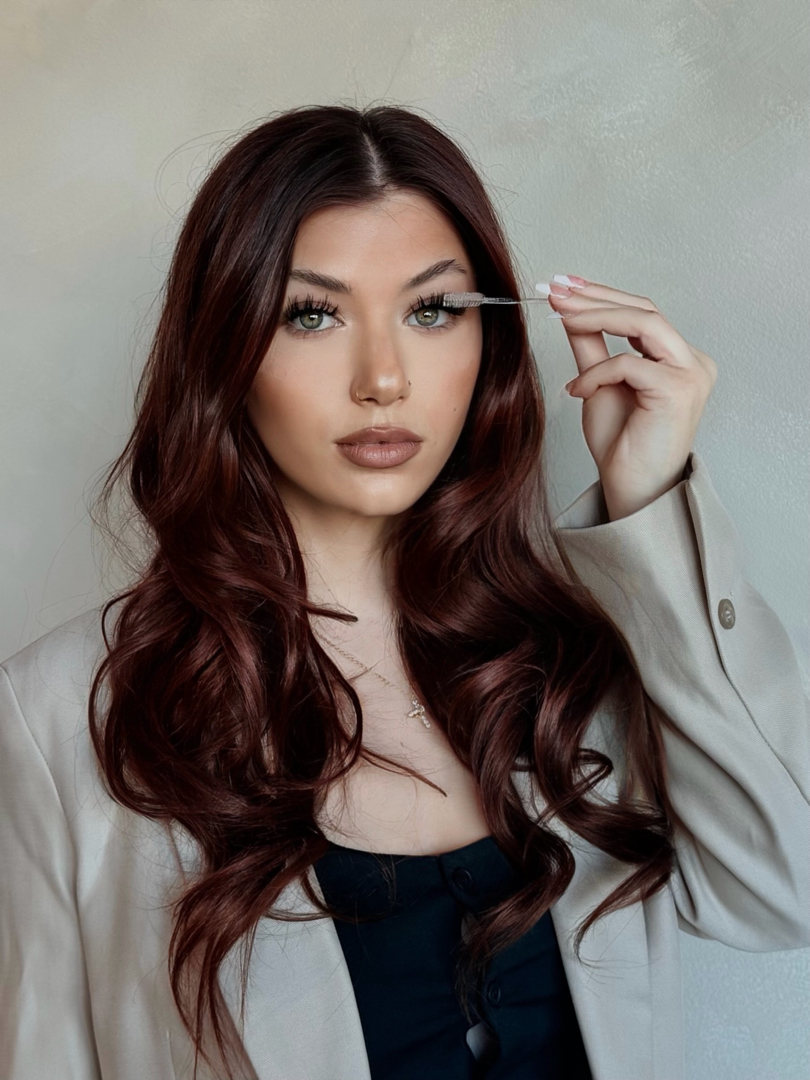 Alaina, owner of Lai’s Lash Co., holding a lash brush in her business portrait